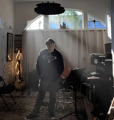 Guitar teacher standing in music studio in La Mesa