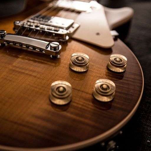 Close up of electric guitar body with pickups and control knobs