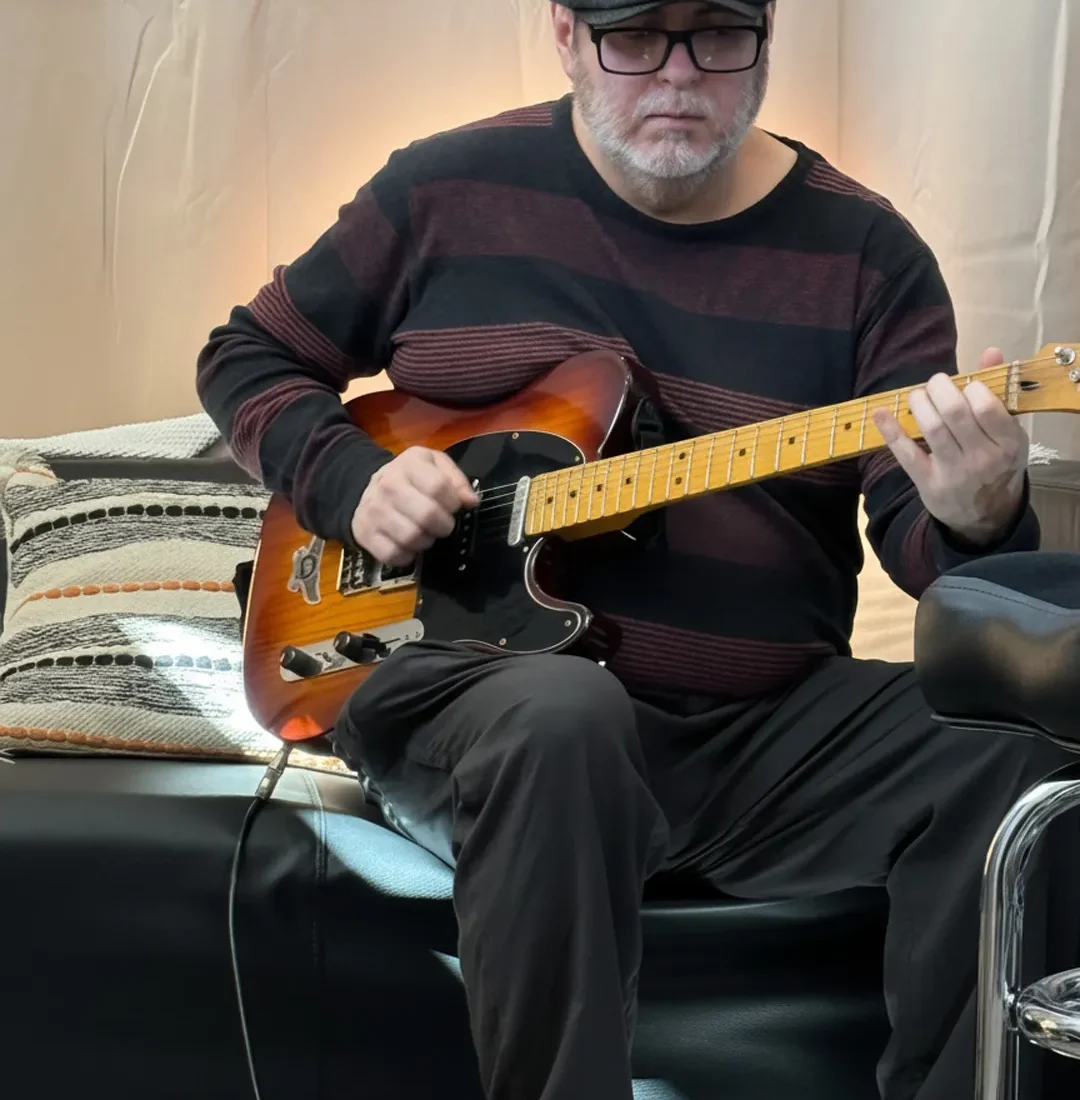 Experienced guitar instructor demonstrating electric guitar techniques during a private lesson at PlayPro Guitar School in La Mesa California