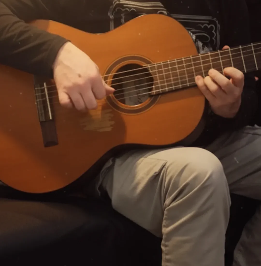 Close up of hands playing a classical acoustic guitar during a personalized guitar lesson in La Mesa California