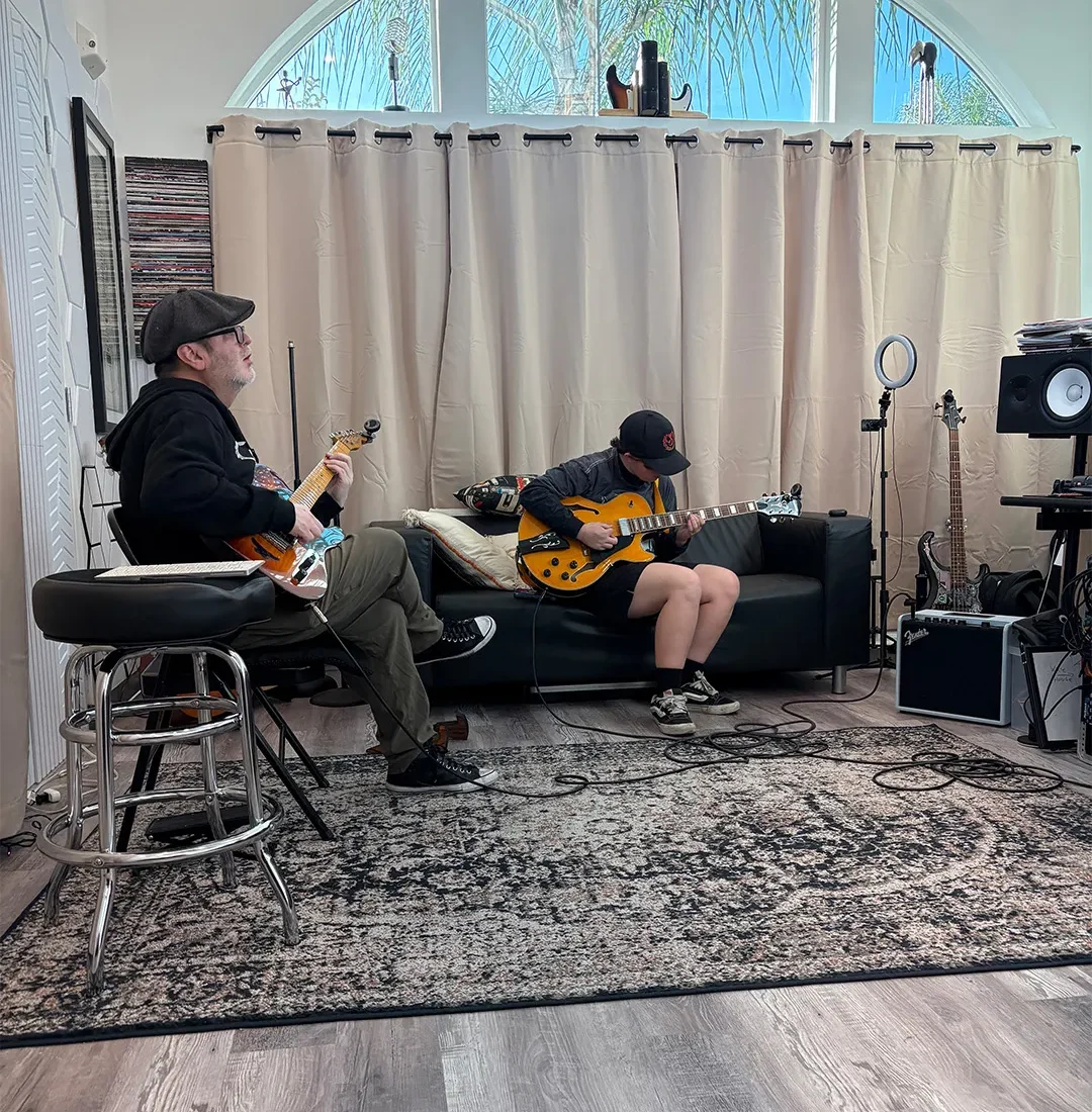 Guitar teacher working one-on-one with a student during an in-studio lesson at PlayPro Guitar School in La Mesa California